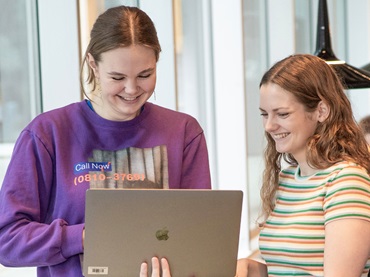 Two women looking at a computer